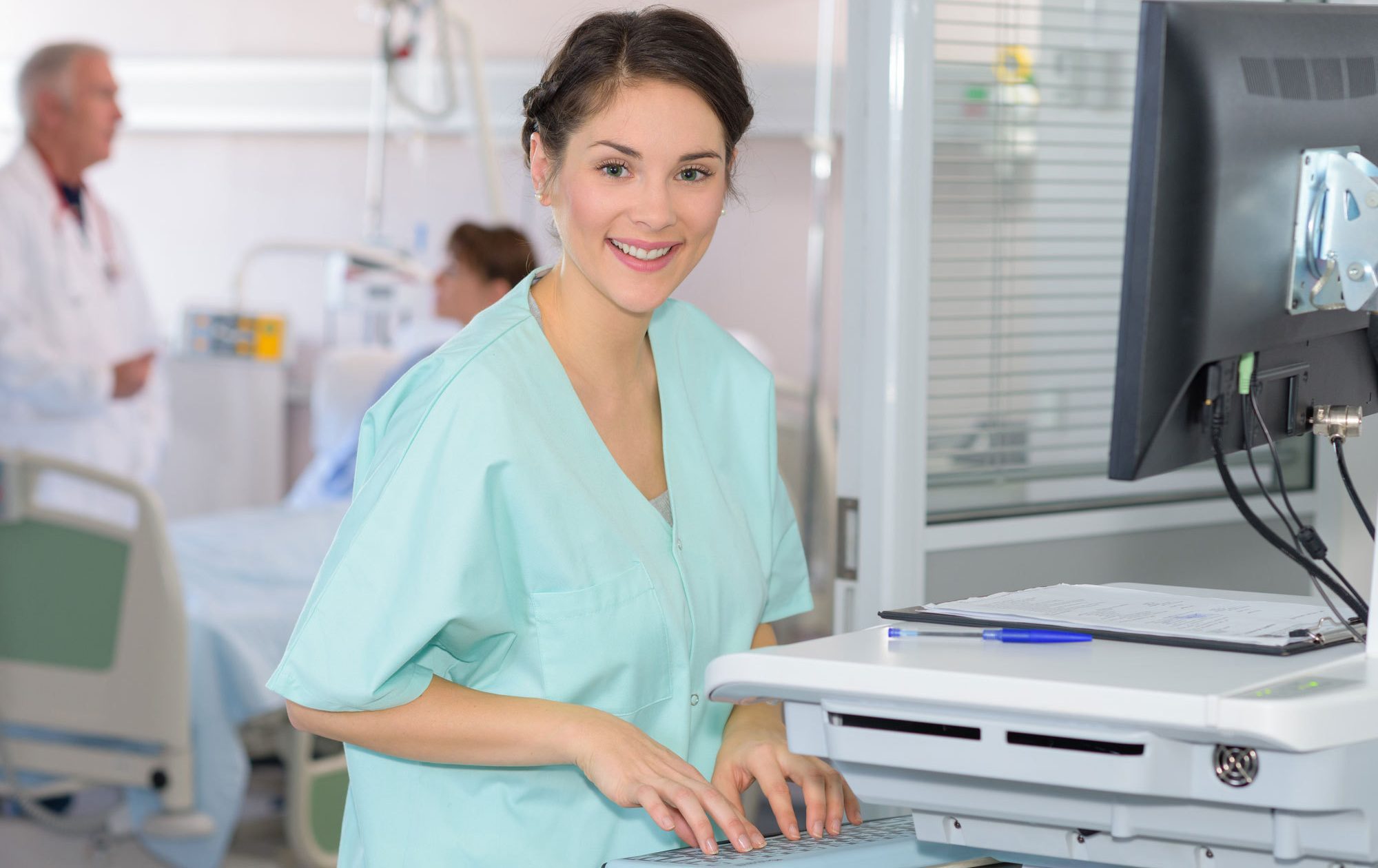 A female BSN is smiling and at work