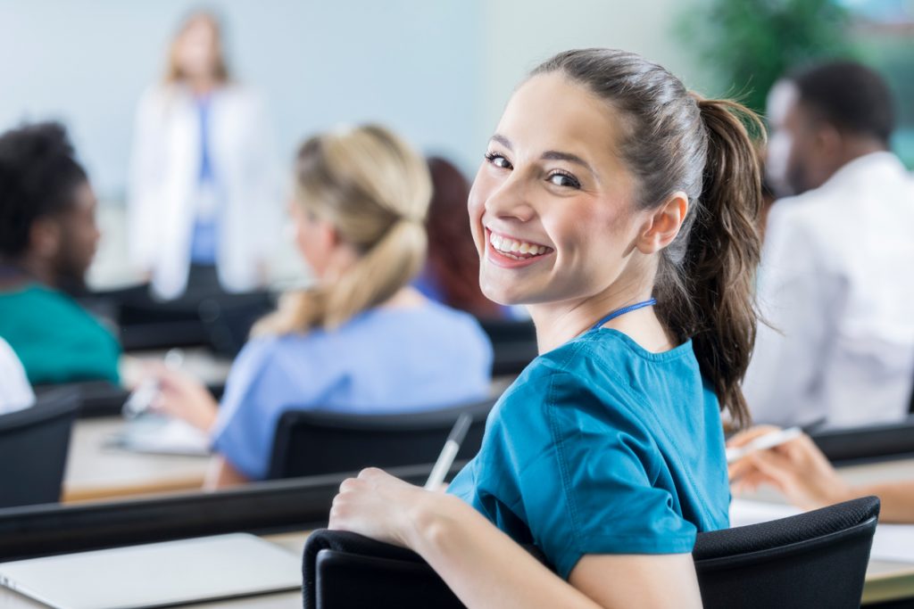 become a registered nurse- what is RN Degree -Cheerful female medical student in the classroom