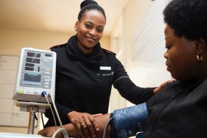 A medical assistant is taking a patient's blood pressure